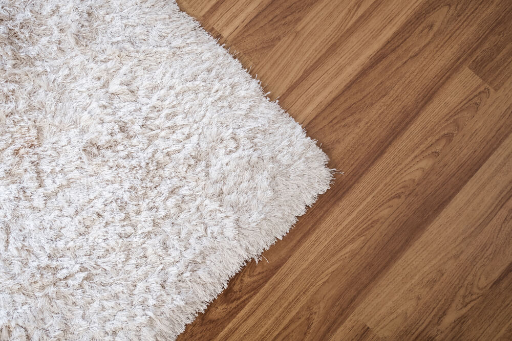 Close-up White Carpet on Laminate Wood Floor in Living Room
