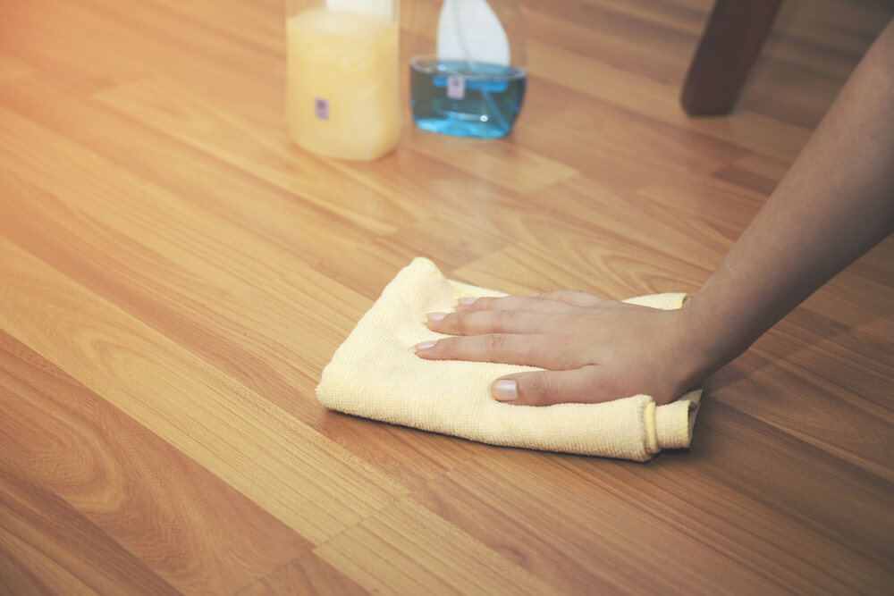 Woman Hand Cleaning an Hardwood Floor With a Microfiber Cloth
