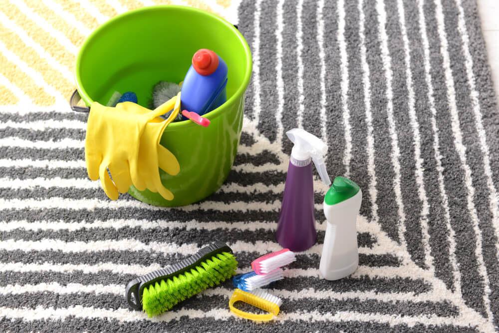 Bucket with cleaning supplies on floor indoors